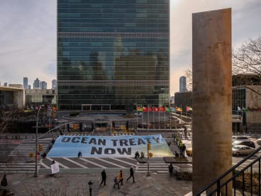 A banner displayed before the United Nations headquarters during ongoing negotiations on a treaty to protect the high seas in New York on Feb 27, 2023.