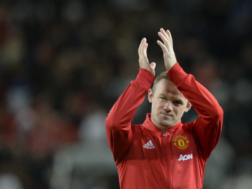 Wayne Rooney applauding as he leaves the pitch. Photo: AFP