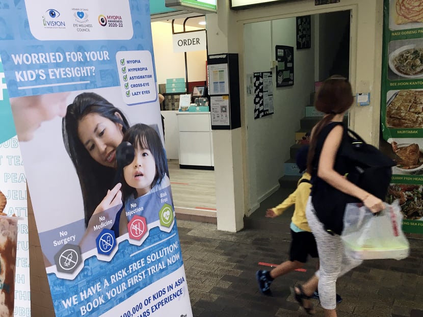 A banner promoting SLM Visioncare's myopia treatment, outside a branch in Bishan.