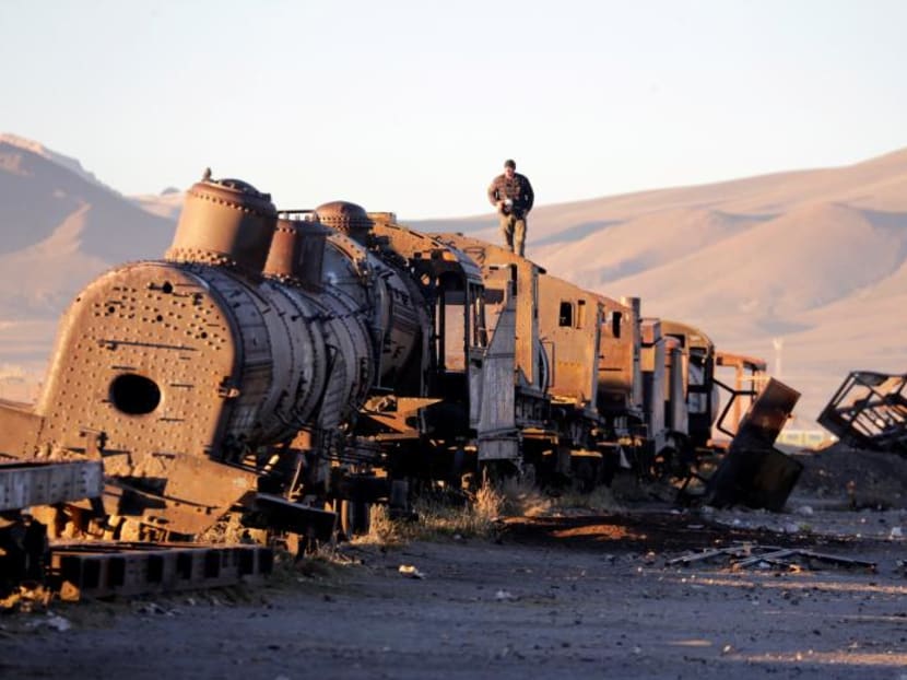 Photo of the day: A man stands on an old train of Bolivian Railways Company from 1870-1900 at the train cemetery in Uyuni, Potosi, Bolivia.
