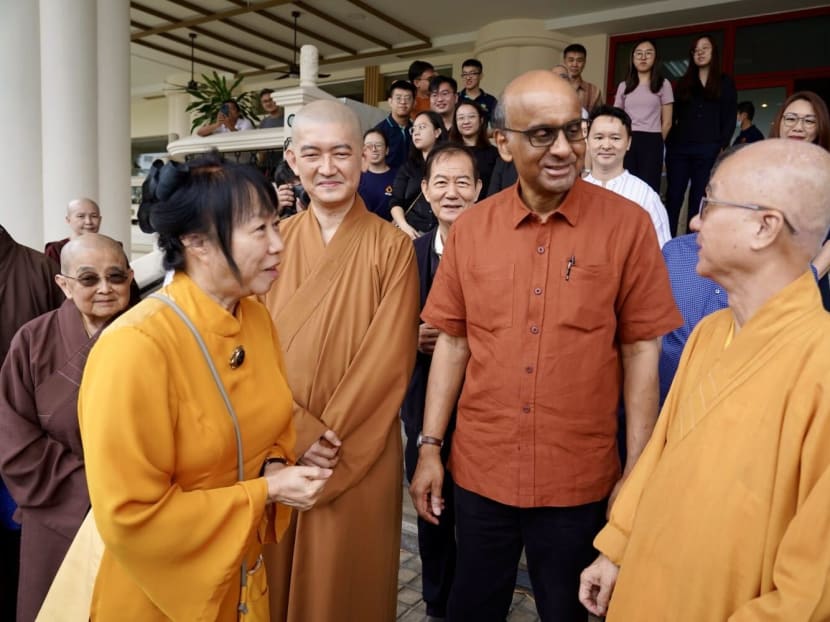 Mr Tharman Shanmugaratnam (second from right) and wife Jane Yumiko Ittogi (left) interacting with monks from the Kong Meng San Phor Kark See Monastery after a dialogue with the temple’s youths.