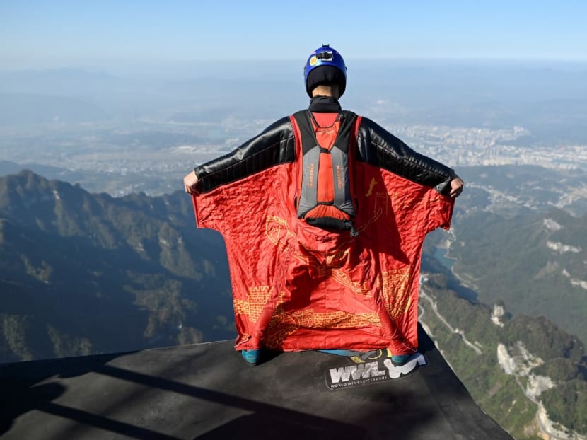 This picture taken on Nov 12, 2020 shows Mr Zhang Shupeng moments before taking flight in a wingsuit jump from Tianmen mountain in Zhangjiajie, China's Hunan province. This picture taken on Nov 12, 2020 shows Mr Zhang Shupeng moments before taking flight in a wingsuit jump from Tianmen mountain in Zhangjiajie, China's Hunan province.