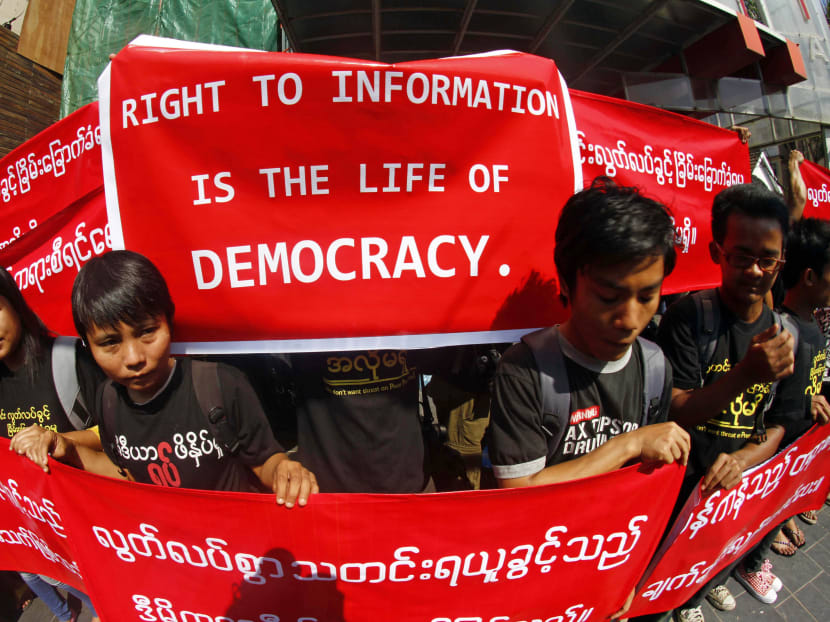 Myanmar journalists hold banners as they protest for Media Freedom outside office of the Eleven Daily Newspaper in Yangon, Jan 7, 2014. Photo: AP