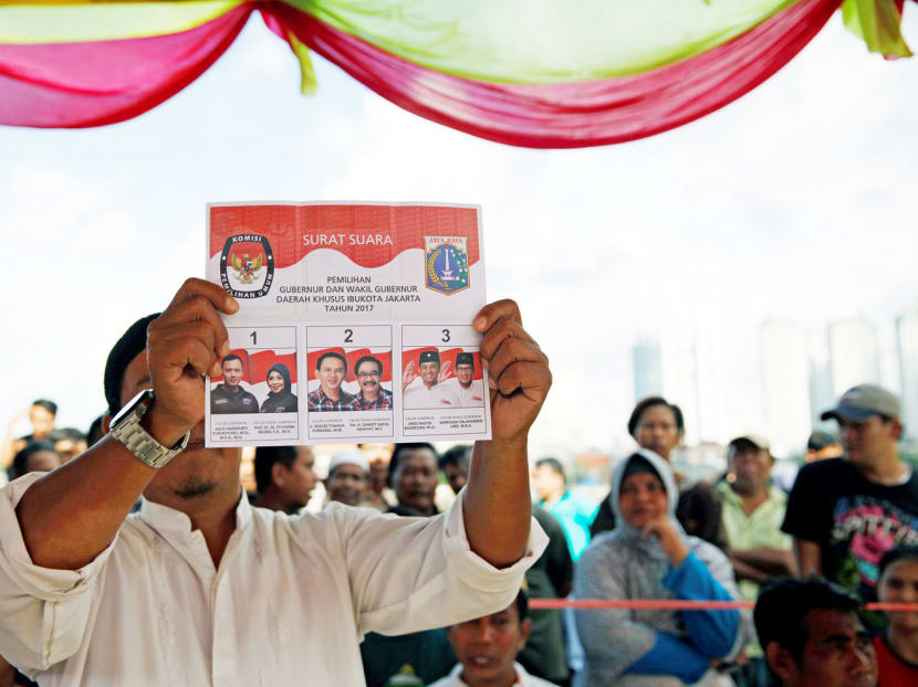 An official showing a ballot paper during the election for the Jakarta Governor yesterday. The job of Governor can be a springboard to the presidency. Photo: Reuters