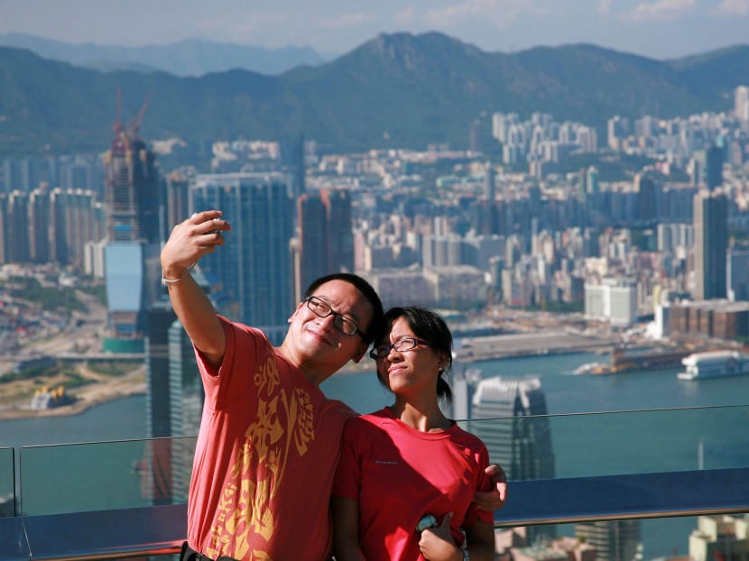 A couple taking a picture of themselves on the Peak, overlooking Victoria Harbour and the Hong Kong skyline. Photo: AFP