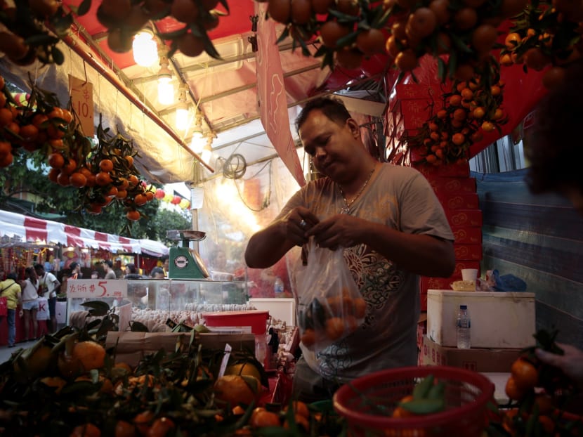 A store owner tends to his Mandarin oranges at Chinatown on Jan 30. Photo: Jason Quah