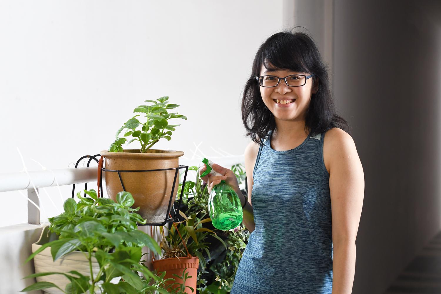 The author Goh Tian and her edible garden with plants such as basil and chilli. 