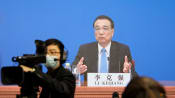 China's economy recovering but foundation not solid, premier says
