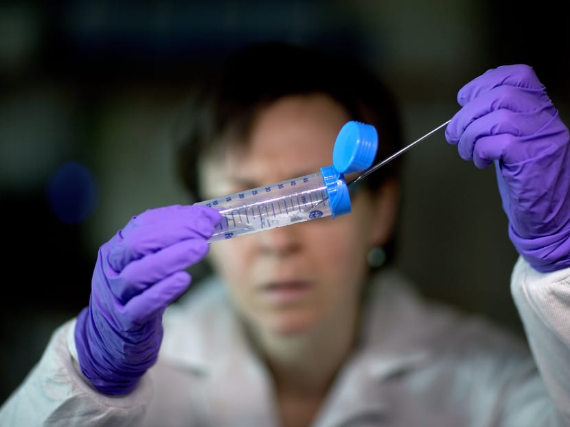 A microbiologist pulling Listeria bacteria from a tube to be tested for its DNA fingerprinting in a foodborne disease outbreak lab. Photo: AP