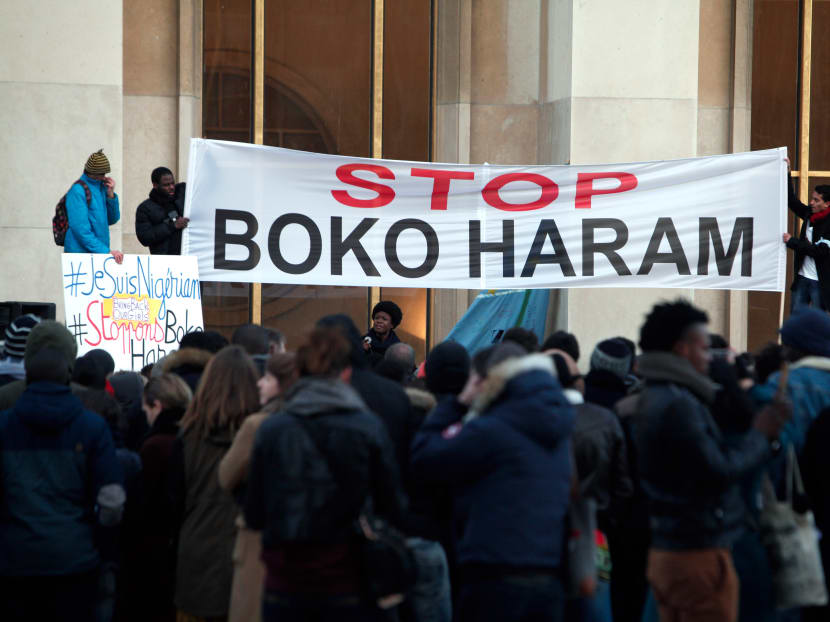 Men hold a banner during a gathering at the Trocadero place, in Paris, Jan 18, 2015 to protest against extremist Islamic group Boko Haram after a large-scale attack in Baga, where as many as 2,000 people were massacred in a raid on Jan 7, 2015. Photo: AP