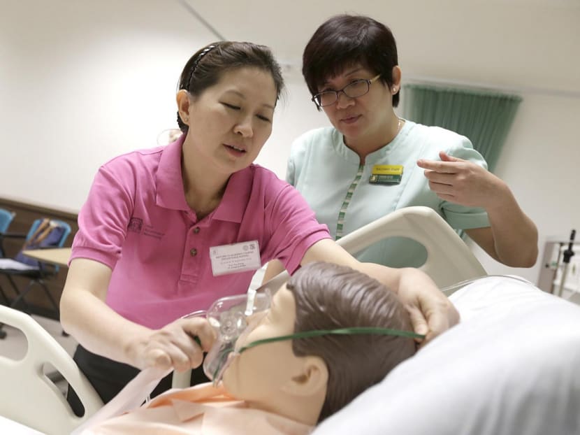 Nurse Educator Cheah Le Le (green) conducting the enhanced RTN refresher course for Sandra Foo Tee Peng (in pink). Photo: Wee Teck Hian