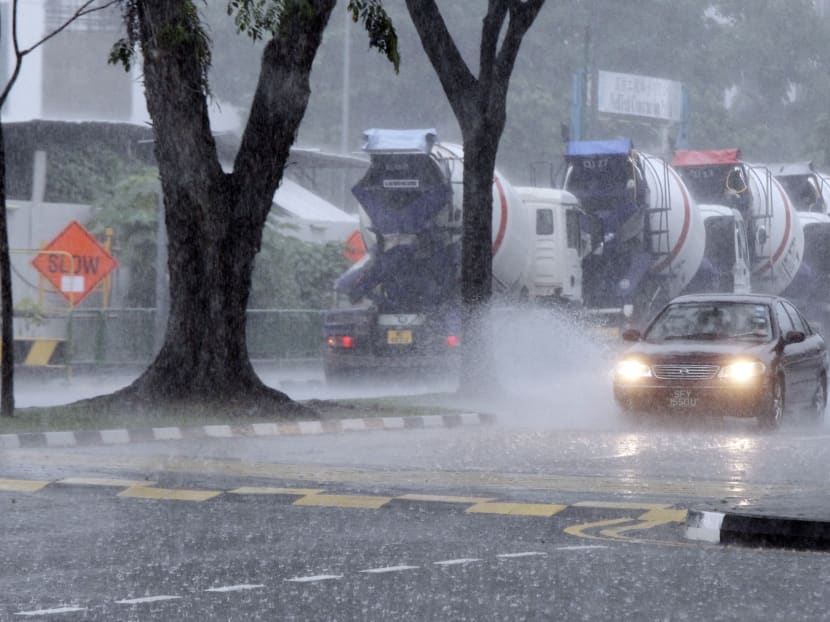 A car driving  along Sin Ming Road with headlight on due to a heavy downpour. TODAY file photo