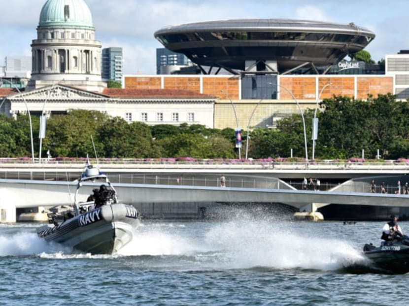 <p>A Republic of Singapore naval boat chases an "intruder" on a jet ski in a preview for a Total Defence Display for the 2022 National Day Parade.</p>
