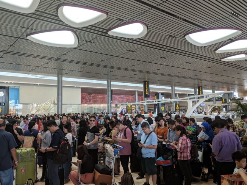 Passengers at the AirAsia check-in counters at Changi Airport Terminal 4 on Monday (June 18).