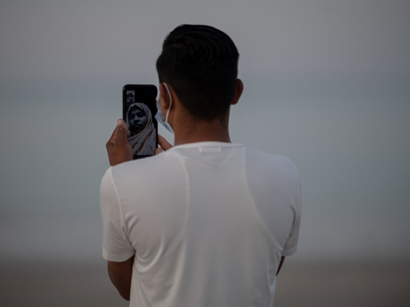 Rohingya refugee "Abdu Hamid" (using a pseudonym) holds his mobile phone on the Malaysian island of Langkawi on Nov 16, 2020 during a video call with his wife who is living at the Kutupalong refugee camp in Ukhia in southern Bangladesh.