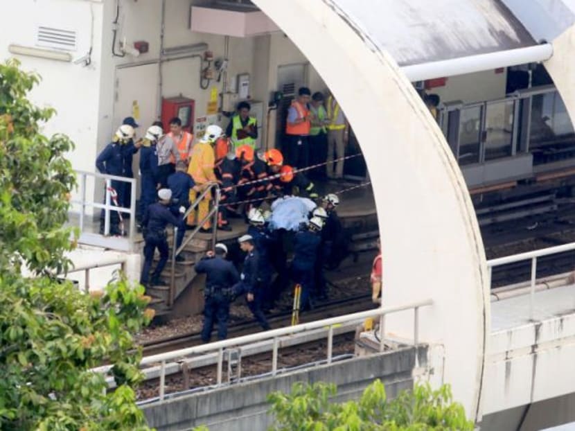 SCDF officers extricate a body from the scene of a train accident on March 22, 2016. TODAY file photo