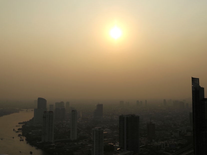 The sun sets over a smoggy Bangkok on January 29.