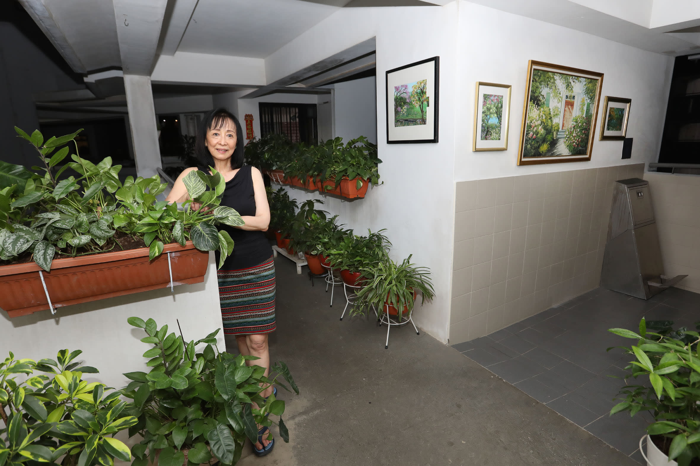 Ms Mary Aw, who lined the corridor outside her Anchorvale Crescent flat with plants and paintings.
