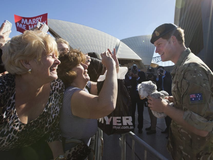 Britain's Prince Harry receives a toy koala from Anne Woods (centre) as he greets well-wishers during a visit to Sydney's Opera House in Australia, May 7, 2015. Harry is ending a month-long attachment with the Australian Defence Force before beginning a week-long tour of New Zealand. Photo: Reuters