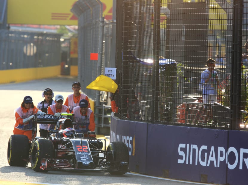 Marshals pushing Jenson Button, McLaren Honda, Formula 1 car during the Practice 1 for 2016 Formula 1 Singapore Airlines Singapore Grand Prix at the Marina Bay Street Circuit on 16 September 2016. The Singapore Grand Prix contract is due to expire next year in 2017. TODAY File Photo