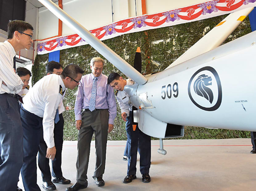 Defence Minister Ng Eng Hen receiving a brief from LTC Timothy Ang (right) on the capabilities of the Hermes 450. Photo: MINDEF