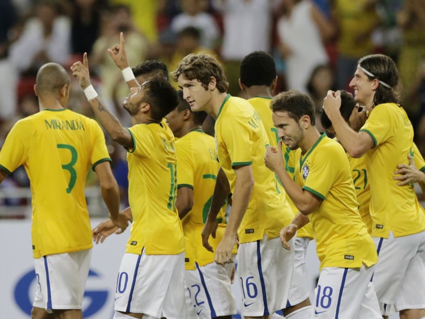 Brazil's Neymar second left, celebrates with his teammates after scoring a goal against Japan during an international friendly soccer match in Singapore, Tuesday, Oct. 14, 2014 in Singapore. Photo: AP