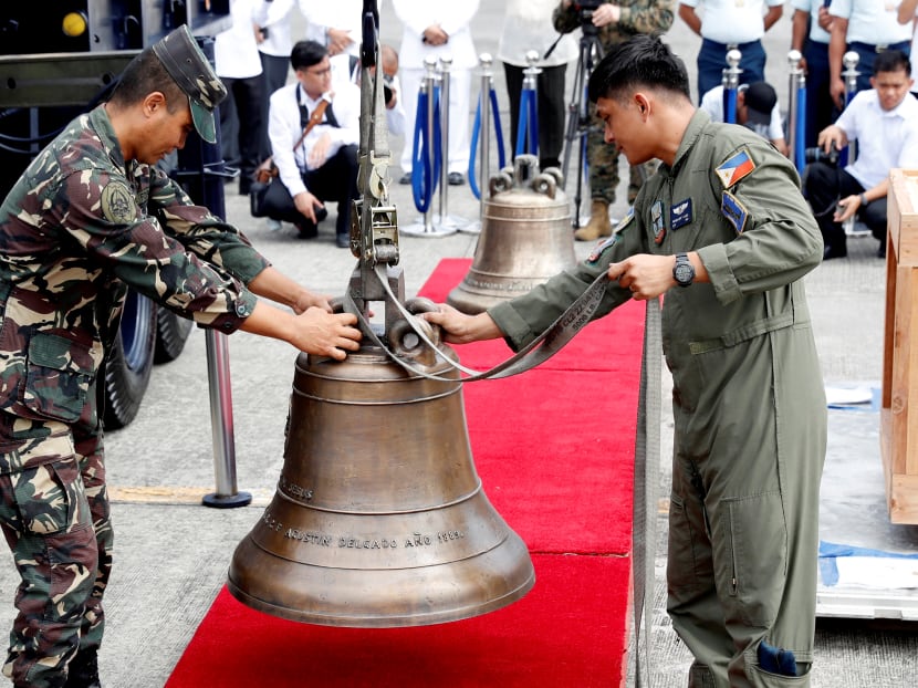 Photo of the day: Philippine Air Force personnel unload the bells of Balangiga after their arrival at Villamor Air Base in Pasay, Metro Manila.