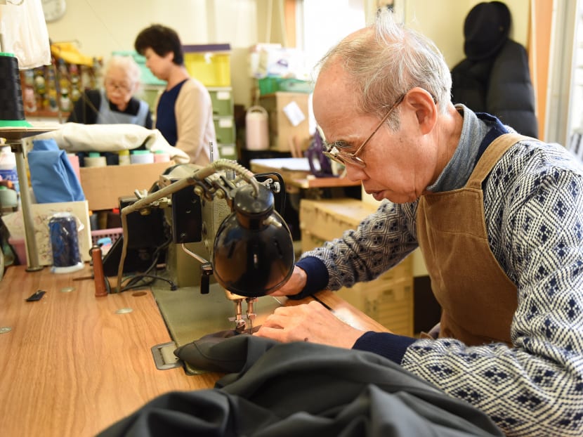 In this picture taken on December 18, 2015, workers repair clothes at a seniors' work centre in Tokyo. Japan's silver-haired workforce is everywhere these days -- from wrinkled men waving glow sticks at construction sites to checkout counter clerks or caregivers for the very old. Photo: AFP