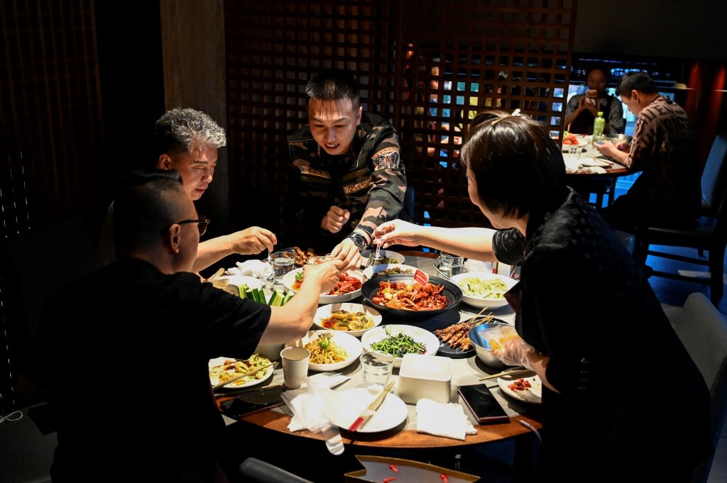People dine at a restaurant in Beijing on June 6, 2022, following an easing of Covid-19 restrictions in the Chinese capital. People dine at a restaurant in Beijing on June 6, 2022, following an easing of Covid-19 restrictions in the Chinese capital.