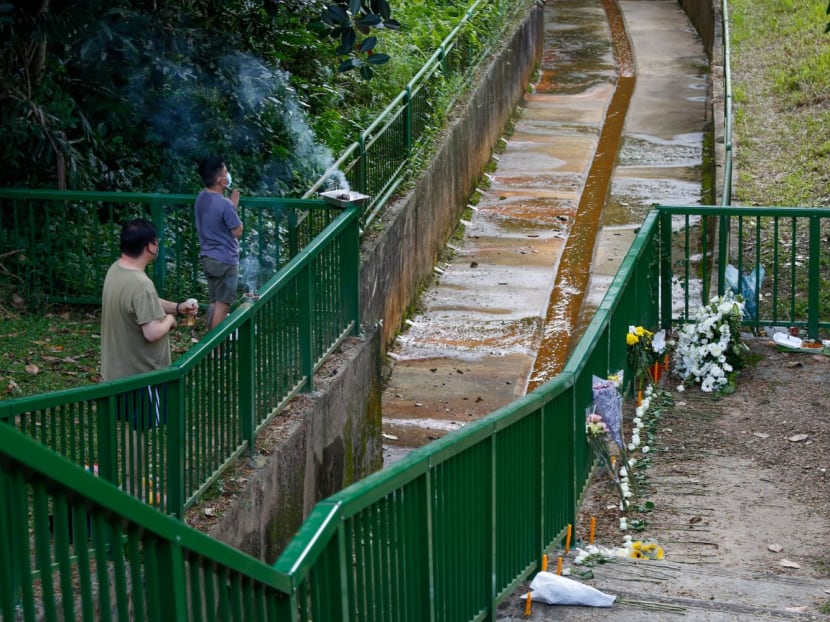 Visitors to a park in the Greenridge Crescent area on Jan 23, 2022, praying next to a drain where the bodies of two boys were said to have been found.