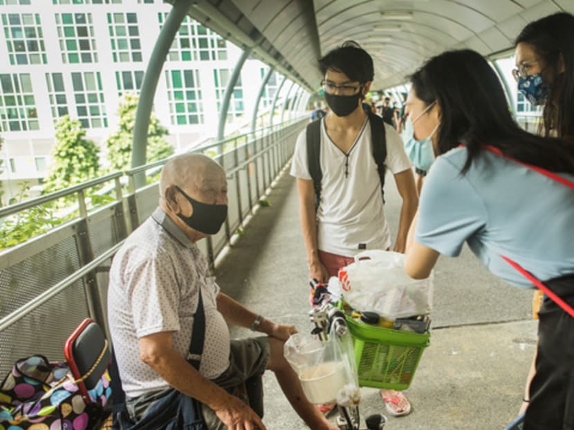 Clockwise from left: A tissue-paper seller in Jurong East talking to Mr Hazeem Nasser, Miss Ada Foo and Miss Nikki Yeo in August 2020.