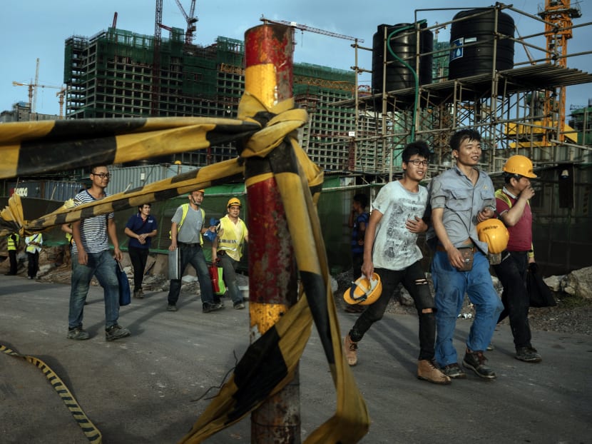 Chinese construction workers walk together after work, in Colombo, Sri Lanka, in June. Sri Lanka had to transfer the strategic port of Hambantota to Chinese ownership after it could no longer keep up with its debt repayments to Chinese creditors