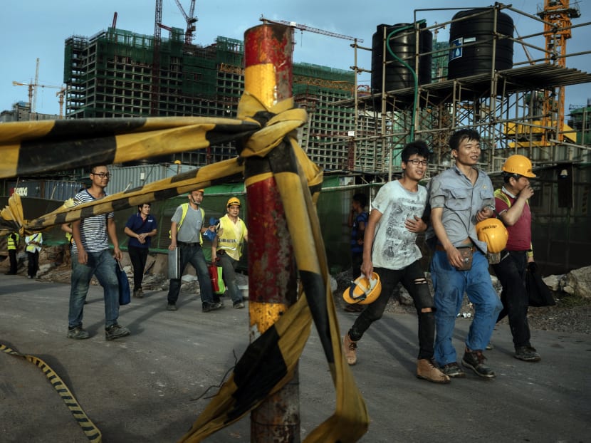 Chinese construction workers walk together after work, in Colombo, Sri Lanka, in June. Sri Lanka had to transfer the strategic port of Hambantota to Chinese ownership after it could no longer keep up with its debt repayments to Chinese creditors Chinese construction workers walk together after work, in Colombo, Sri Lanka, in June. Sri Lanka had to transfer the strategic port of Hambantota to Chinese ownership after it could no longer keep up with its debt repayments to Chinese creditors