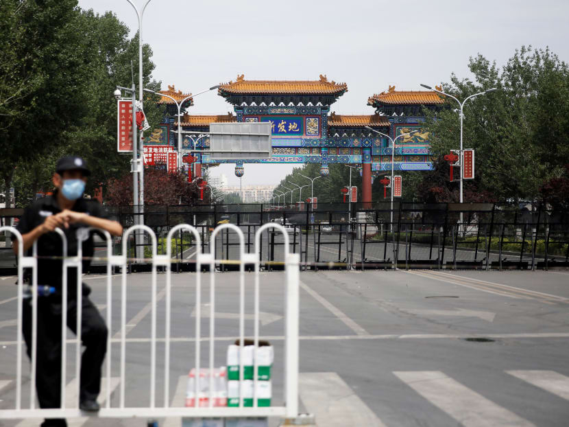 A security officer at a blocked entrance to the Xinfadi wholesale market in Beijing, which has been closed following cases of Covid-19 infections.