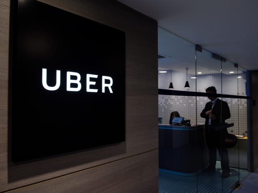 An employee standing in the entrance of Uber's office in Hong Kong. AFP file photo