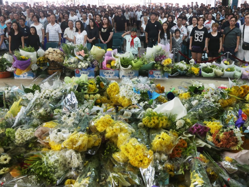 Members of the public sing the National Anthem at the end of the State Funeral of the late Mr Lee Kuan Yew at Ang Mo Kio Town Centre on 29 March 2015. Photo: Ooi Boon Keong