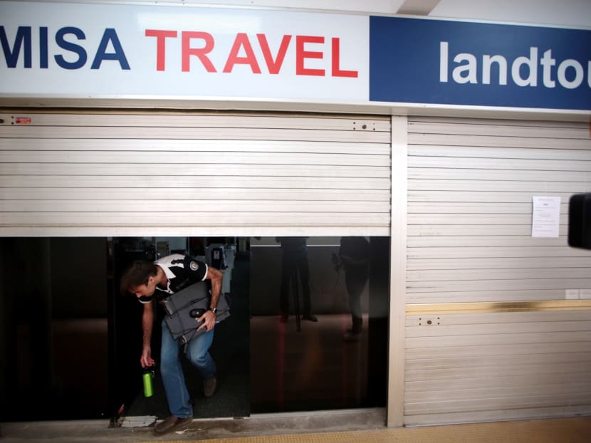 A man, who did not speak to the media, emerges from the shuttered offices of Misa Travel on June 1, 2017. Photo: Jason Quah/TODAY A man, who did not speak to the media, emerges from the shuttered offices of Misa Travel on June 1, 2017. Photo: Jason Quah/TODAY