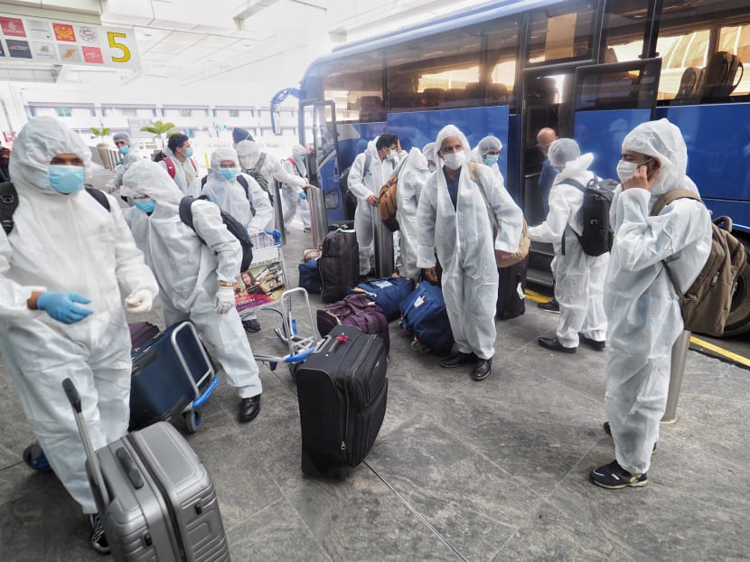 Seafarers who have been stranded on ships arriving at Changi Airport on June 12, 2020 to finally board a flight home to Mumbai, India.