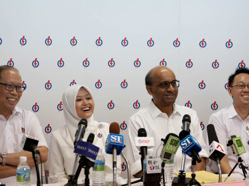 (From left to right) PAP candidate for Bukit Batok SMC David Ong, PAP candidates for Jurong GRC Mdm Rahayu Mahzam, Mr Tharman Shanmugaratnam, and Dr Tan Wu Meng react during a press conference on Aug 20, 2015. Photo: Jason Quah