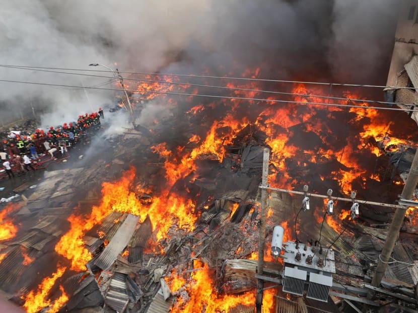 Firefighters try to extinguish a fire that broke out in a clothing market in Dhaka on April 4, 2023.