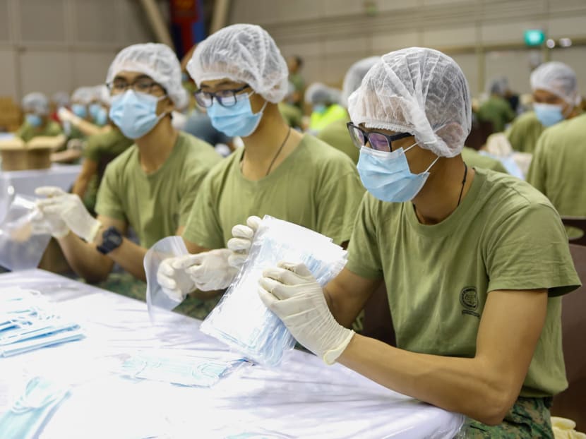 Singapore Armed Forces personnel packing masks at Safti Military Institute.
