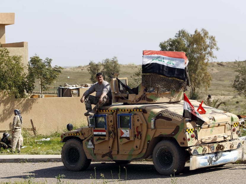 An Iraqi soldier sits on a military vehicle at Udhaim dam, north of Baghdad on March 1, 2015. Photo: Reuters