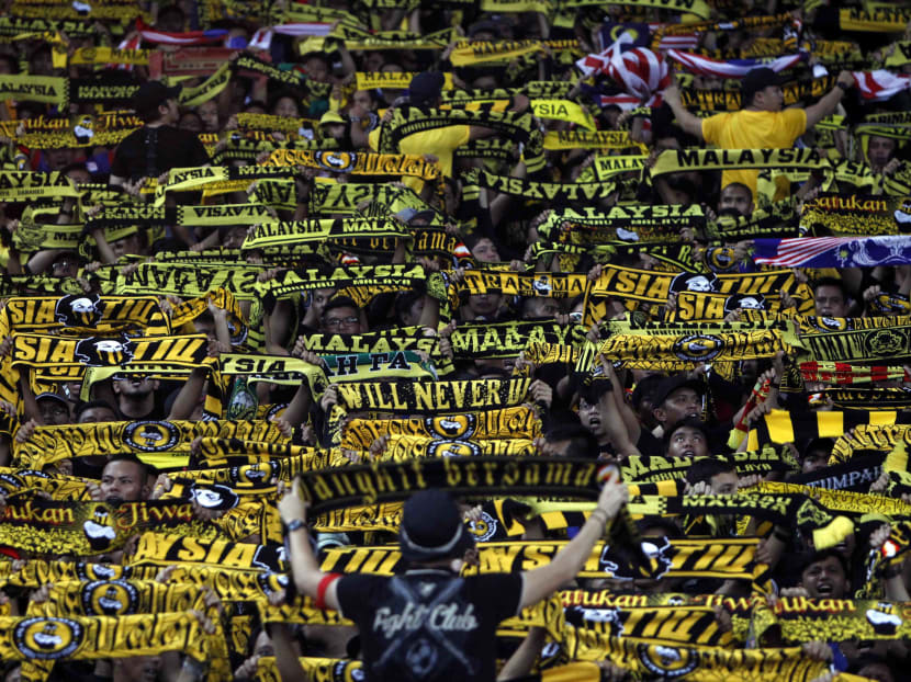 Malaysian supporters cheer before the start of the final second leg soccer match. AP file photo