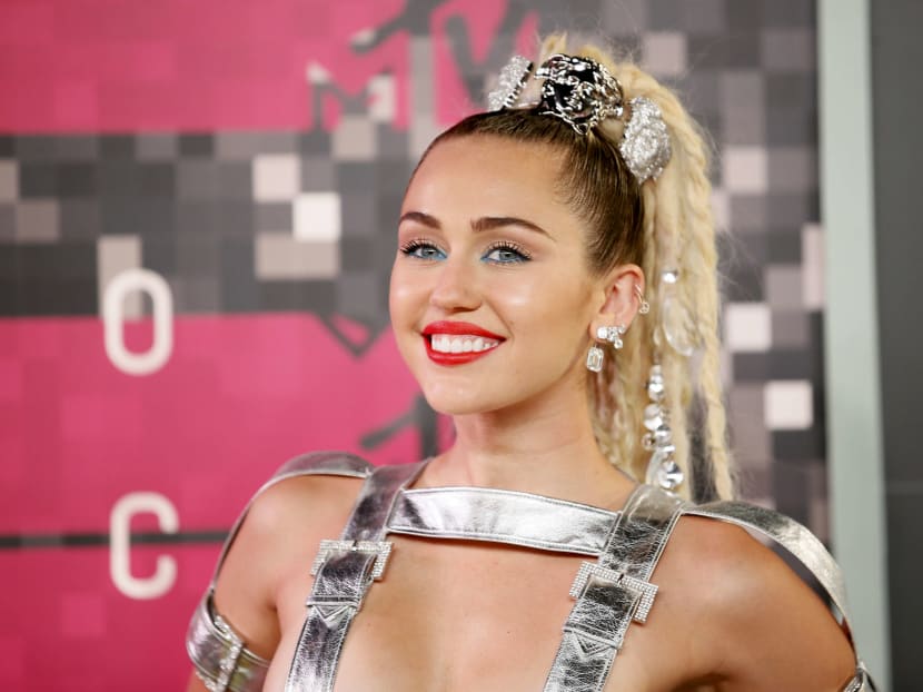Miley Cyrus shakes in barely there silver straps at VMAs
