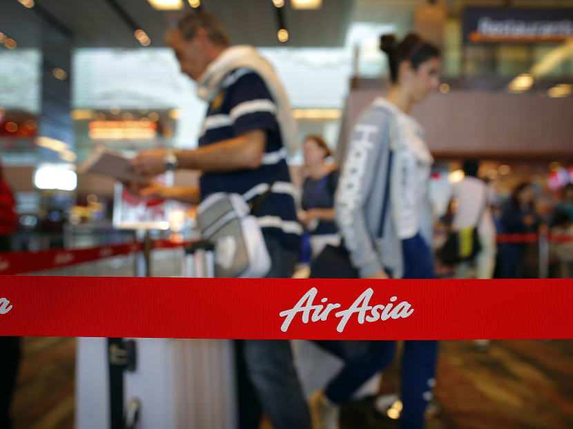 Passengers queue at AirAsia's check-in counters in 2014. Photo: AP