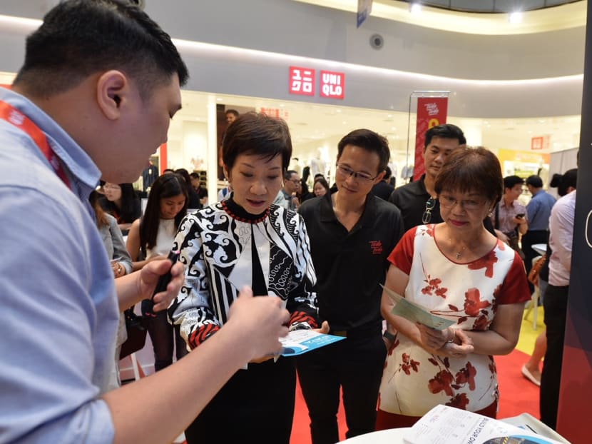 Minister Grace Fu, Mr Desmond Choo (Assistant Secretary-General of NTUC and Executive Secretary of Young NTUC) and Ms Denise Phua (Mayor of Central Singapore District) talking to one of the learning partners, Gen Infiniti Academy at Todo Todo Skills Marketplace @ Central Singapore.