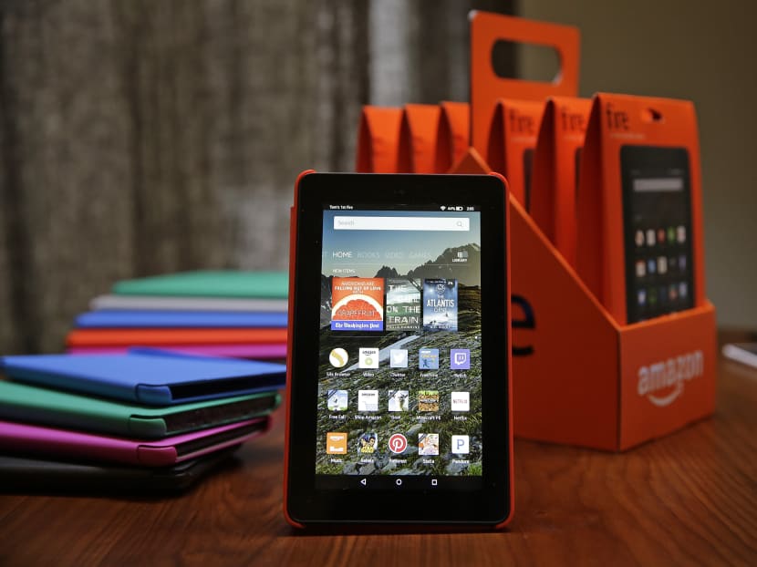 Amazon's new budget-friendly US$50 (S$70) Fire tablet is displayed next to a six-pack of them and assorted coloured cases in San Francisco. Photo: AP