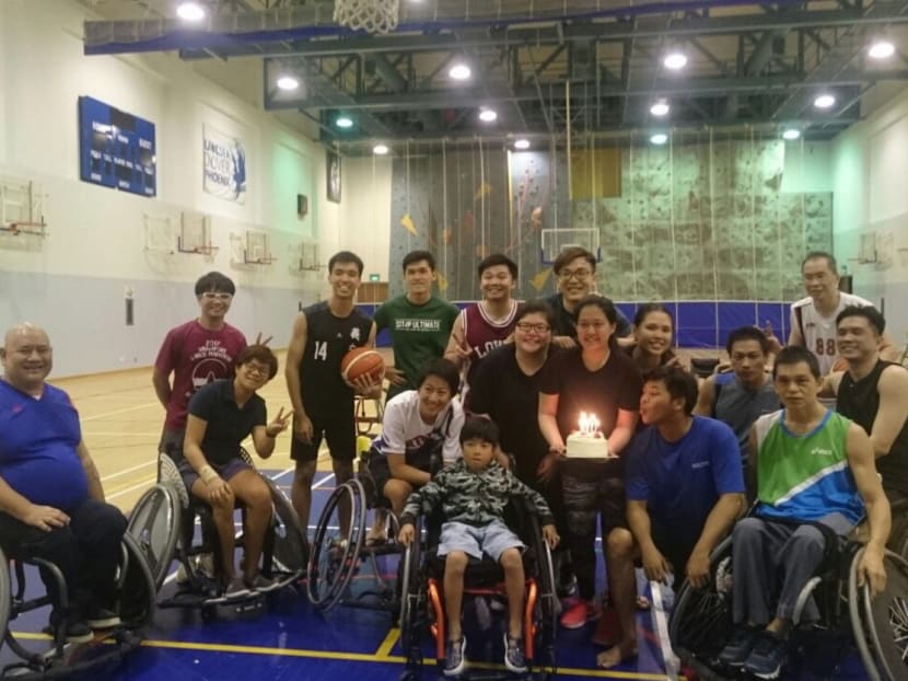 Mr Alan Tan (second row, second from right) enjoys hanging out with his peers to play wheelchair basketball. He had polio as a child, but does not let his condition get in the way of work or having a social life. Photo: Alan Tan