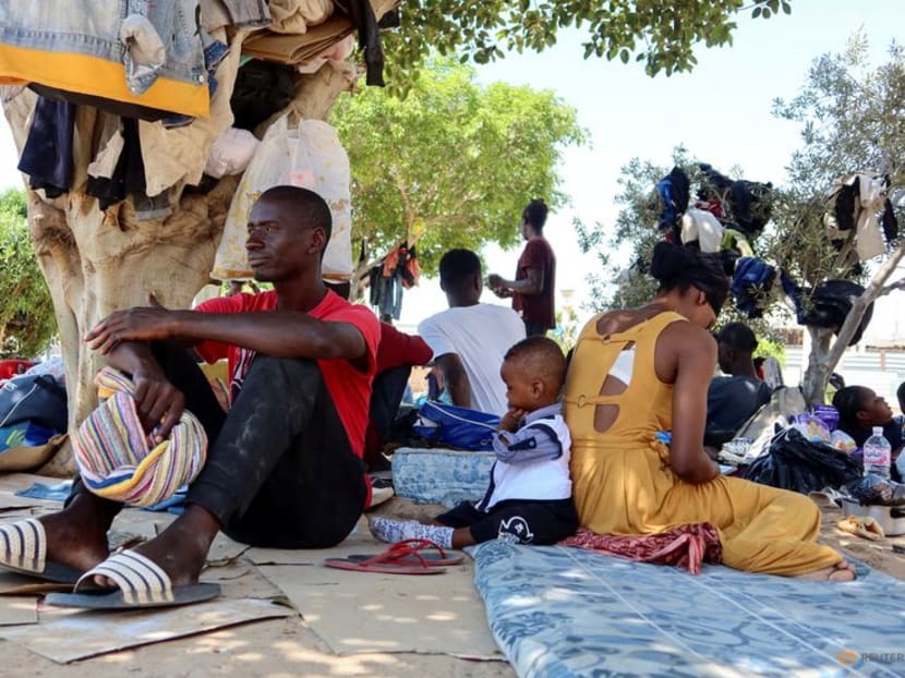 FILE PHOTO: A migrant from Guinea, Paldy Soulima, sits with other migrants in a public garden in Sfax, Tunisia July 13, 2023. REUTERS/Jihed Abidellaoui/File Photo