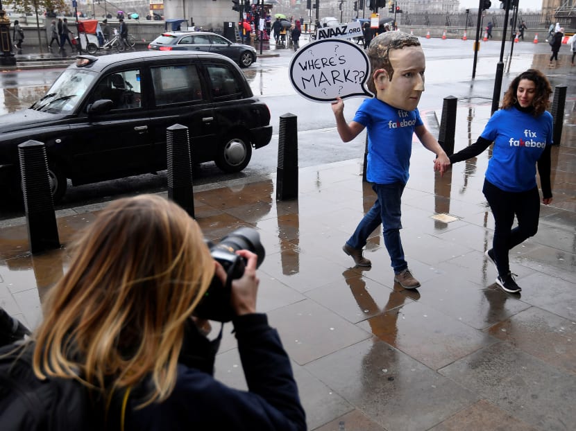 A campaigner from a political pressure group wears an oversized mask of Facebook founder Mark Zuckerberg after he failed to attend a meeting on fake news held by a British Parliamentary committee in November.